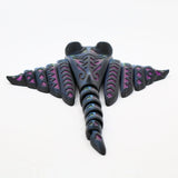 Colorful 3D printed sensory stingray toy with geometric patterns on white background