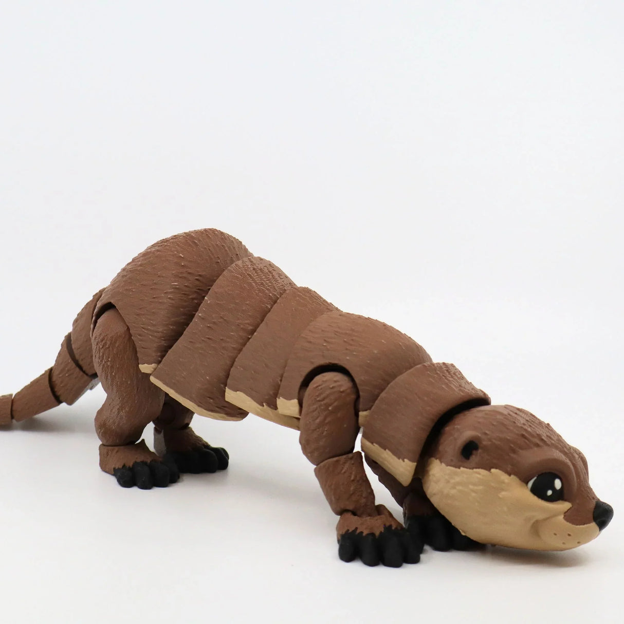 Brown 3D printed sea otter sensory toy with movable joints on a white background