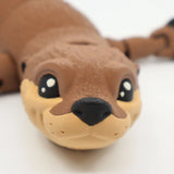 Close-up of a 3D printed sea otter sensory toy with textured brown and beige surface