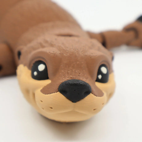 Close-up of a 3D printed sea otter sensory toy with textured brown and beige surface