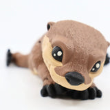 Cute 3D printed sea otter sensory toy with textured surface on white background
