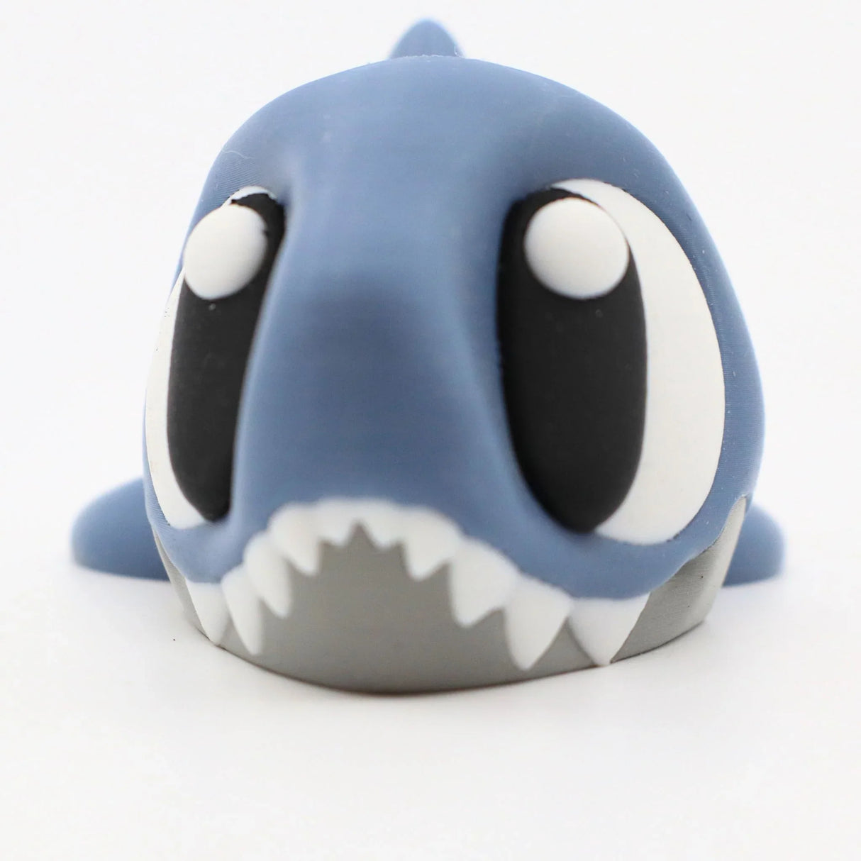 Cute blue 3D printed shark sensory toy with big eyes, perfect for sensory play