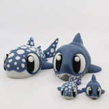 Cute 3D printed shark sensory toys with large eyes, blue bodies, and white spots