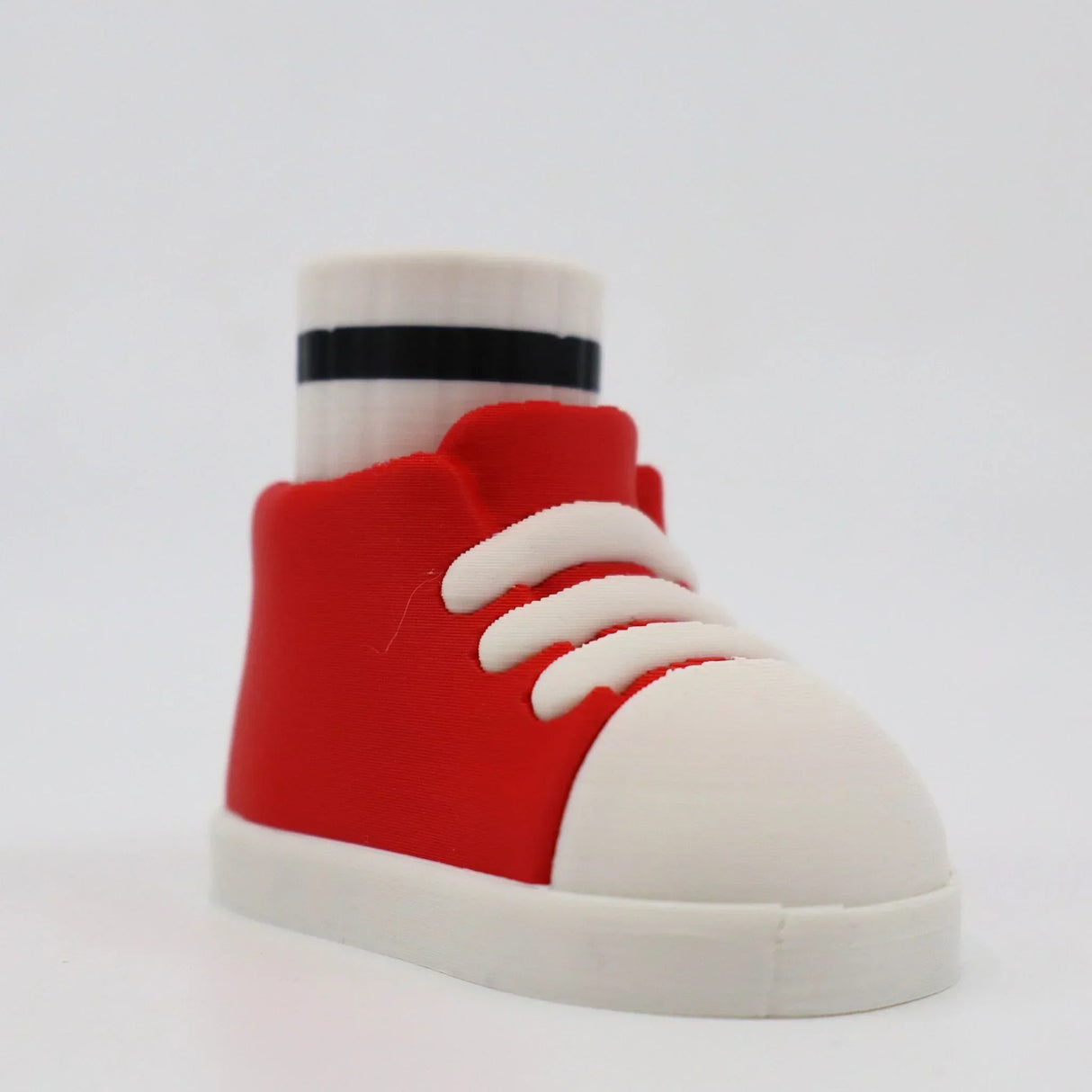 Red and white 3D printed sneaker fidget toy with sock, sensory-friendly design for kids