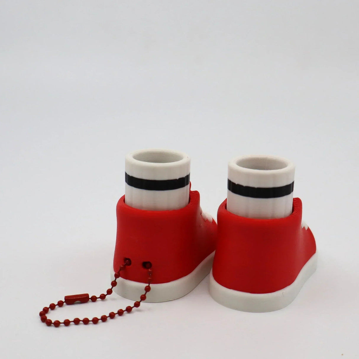 Red and white 3D printed fidget toy sneakers with black stripe and ball chain, sensory toy for kids