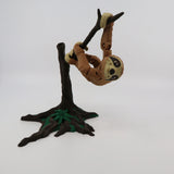 3D printed sloth sensory toy hanging from a tree branch with movable joints.