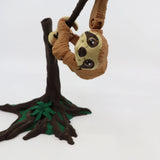 3D printed sloth sensory toy hanging from tree branch, brown and green, educational toy