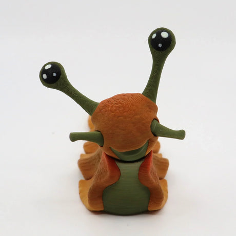 Colorful 3D printed slug sensory toy with green and orange segments, cute eyes, on white background.