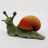 3D printed sensory snail toy with green body and orange shell on white background