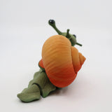 3D printed sensory snail toy with orange spiral shell on a white background