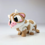 Cute 3D printed sensory toy cow with brown spots, big eyes, and a playful design