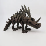 3D printed brown Styracosaurus dinosaur sensory toy with spikes and moving joints on white background