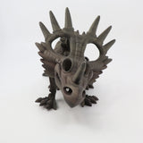 3D printed Styracosaurus dinosaur sensory toy with textured brown finish on white background