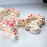 3D printed sensory dragon toy in pastel colors with textured scales and heart-shaped tail