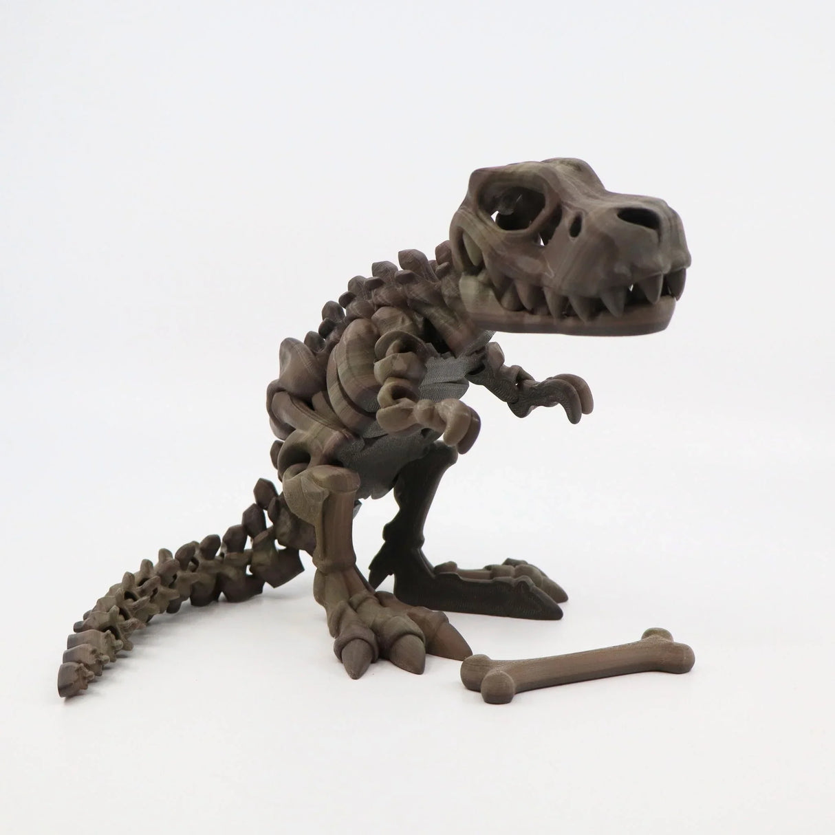 3D printed T-Rex dinosaur sensory toy in brown, posed with a bone on a white background
