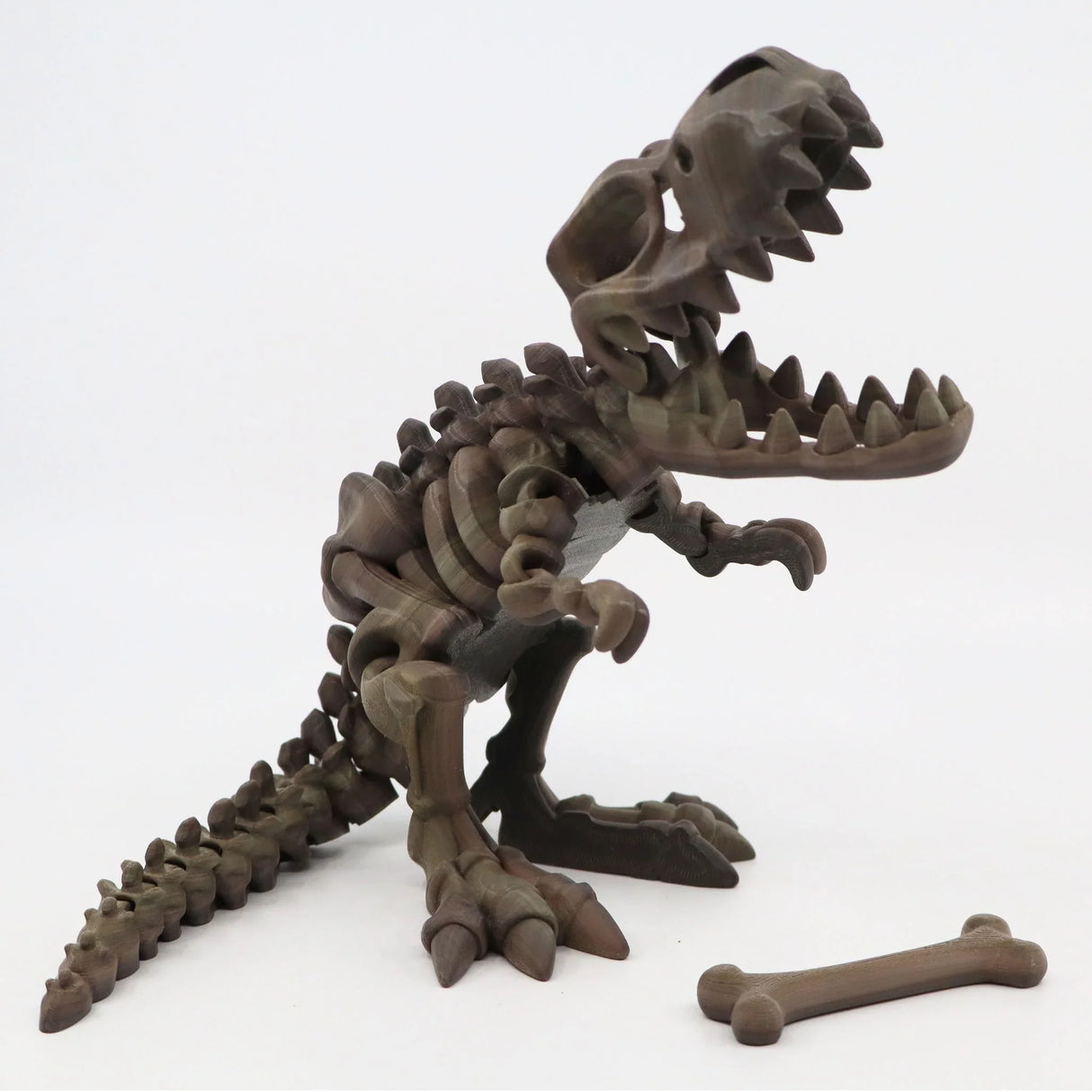 3D printed T-Rex dinosaur skeleton sensory toy with detachable bone on white background