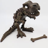 3D printed T-Rex dinosaur skeleton sensory toy with separate bone piece on white background