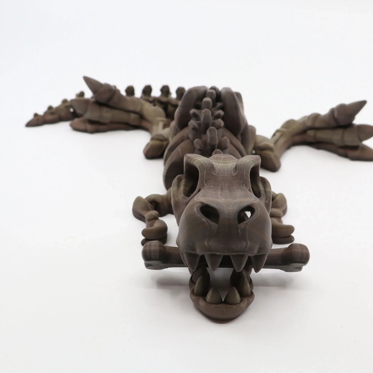 3D printed T-Rex sensory toy, brown articulated dinosaur with movable limbs on white background