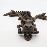 3D printed T-Rex sensory toy, brown articulated dinosaur with movable limbs on white background