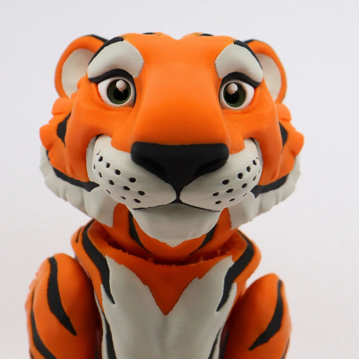 3D printed orange tiger sensory toy with black stripes and expressive eyes on white background