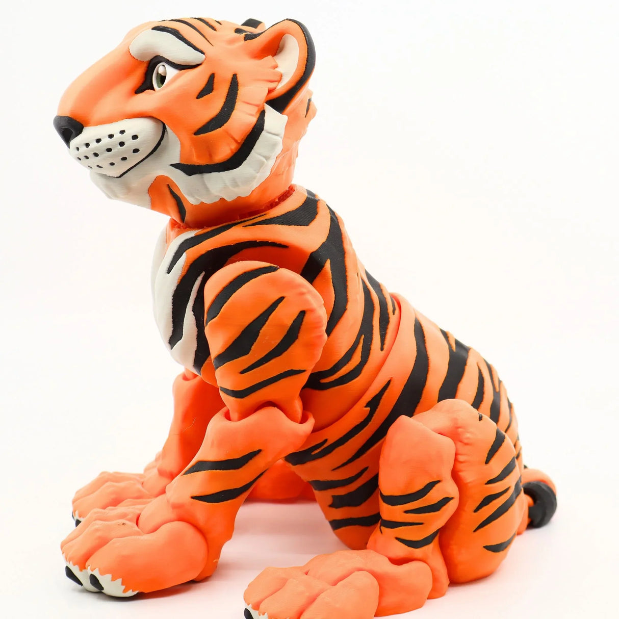 3D printed orange and black tiger sensory toy with articulated limbs, side view