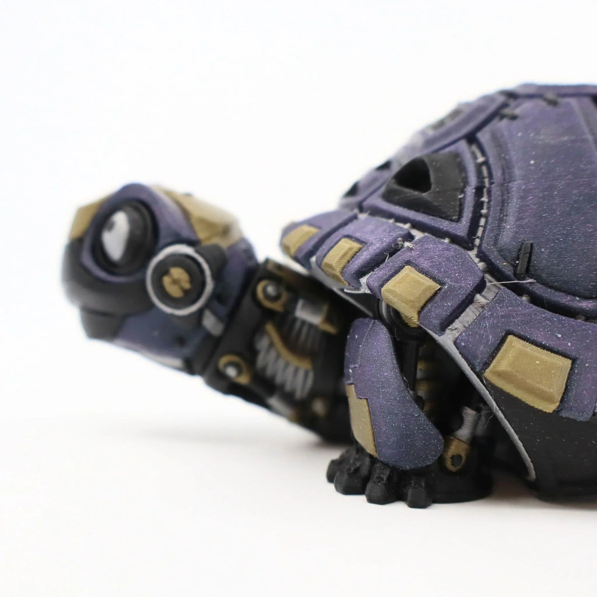 Purple and gold 3D printed tortoise sensory toy with articulated segments on white background