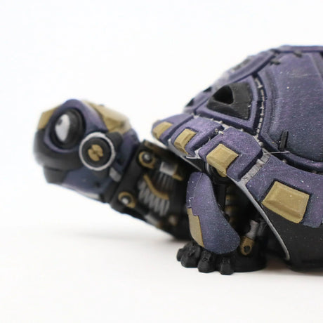 Purple and gold 3D printed tortoise sensory toy with articulated segments on white background