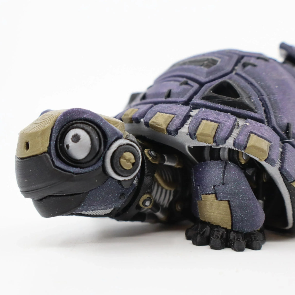 3D printed purple and gold flexi tortoise sensory toy on white background
