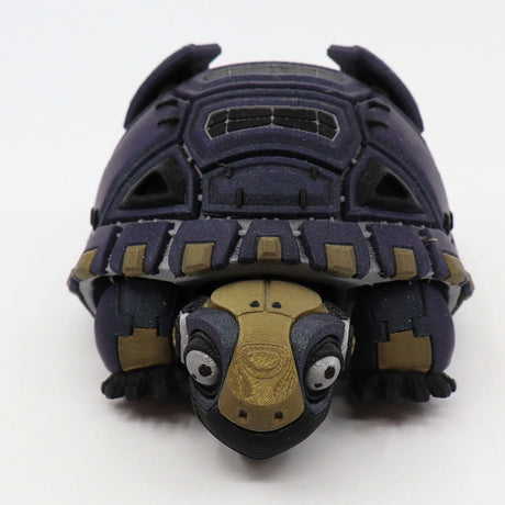 Purple and gold 3D printed sensory tortoise toy with articulated shell on white background