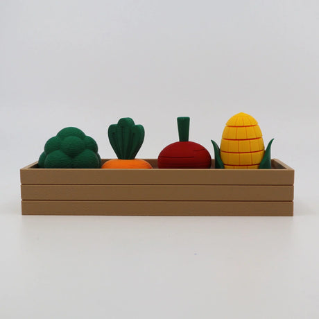 3D printed sensory toy vegetables in a brown tray, including broccoli, carrot, beet, and corn