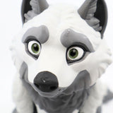 3D printed gray and white wolf sensory toy with green eyes, close-up view