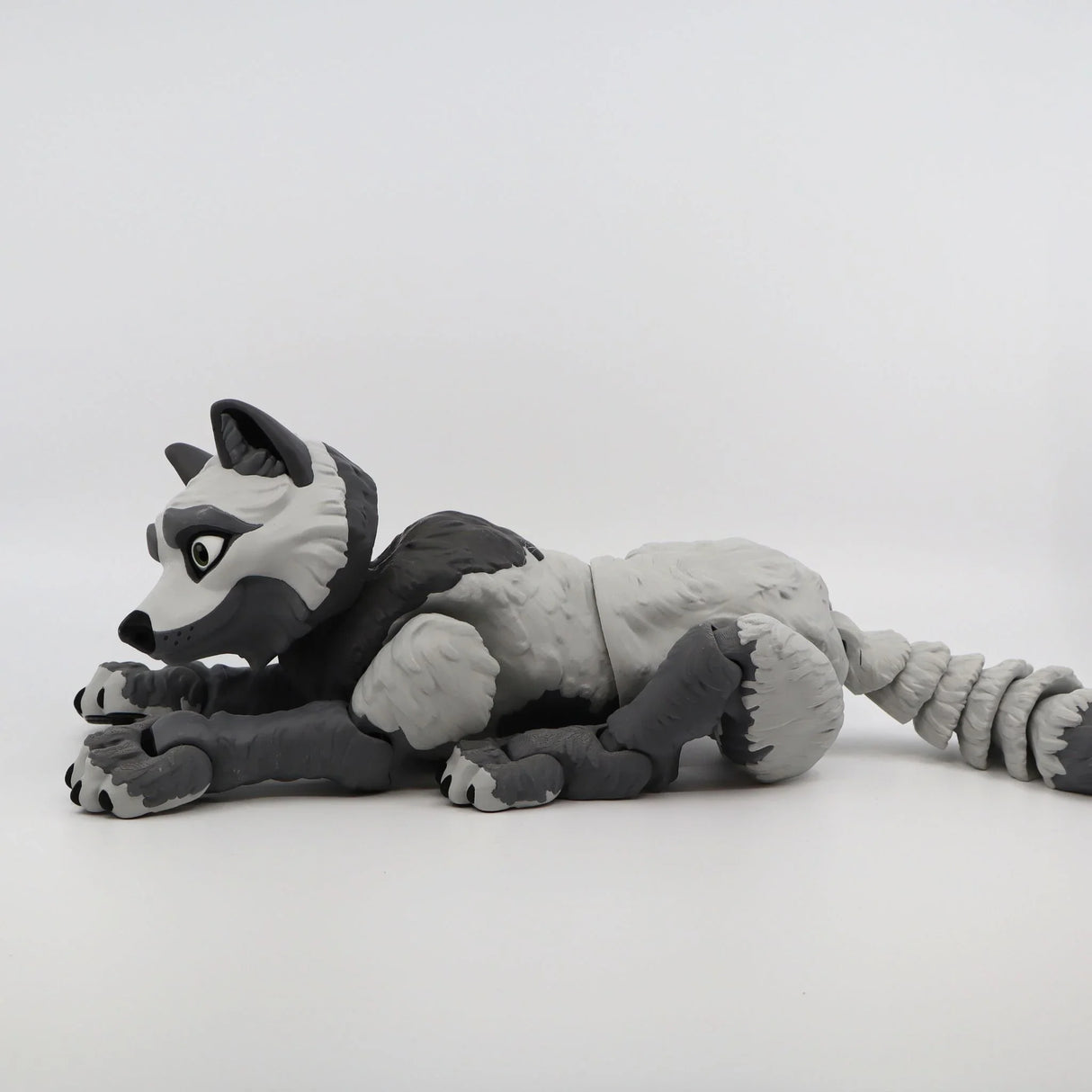Gray 3D printed wolf sensory toy lying down, flexible and textured for tactile play