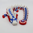 3D printed patriotic flexi dragon with stars, stripes, and shield for sensory play