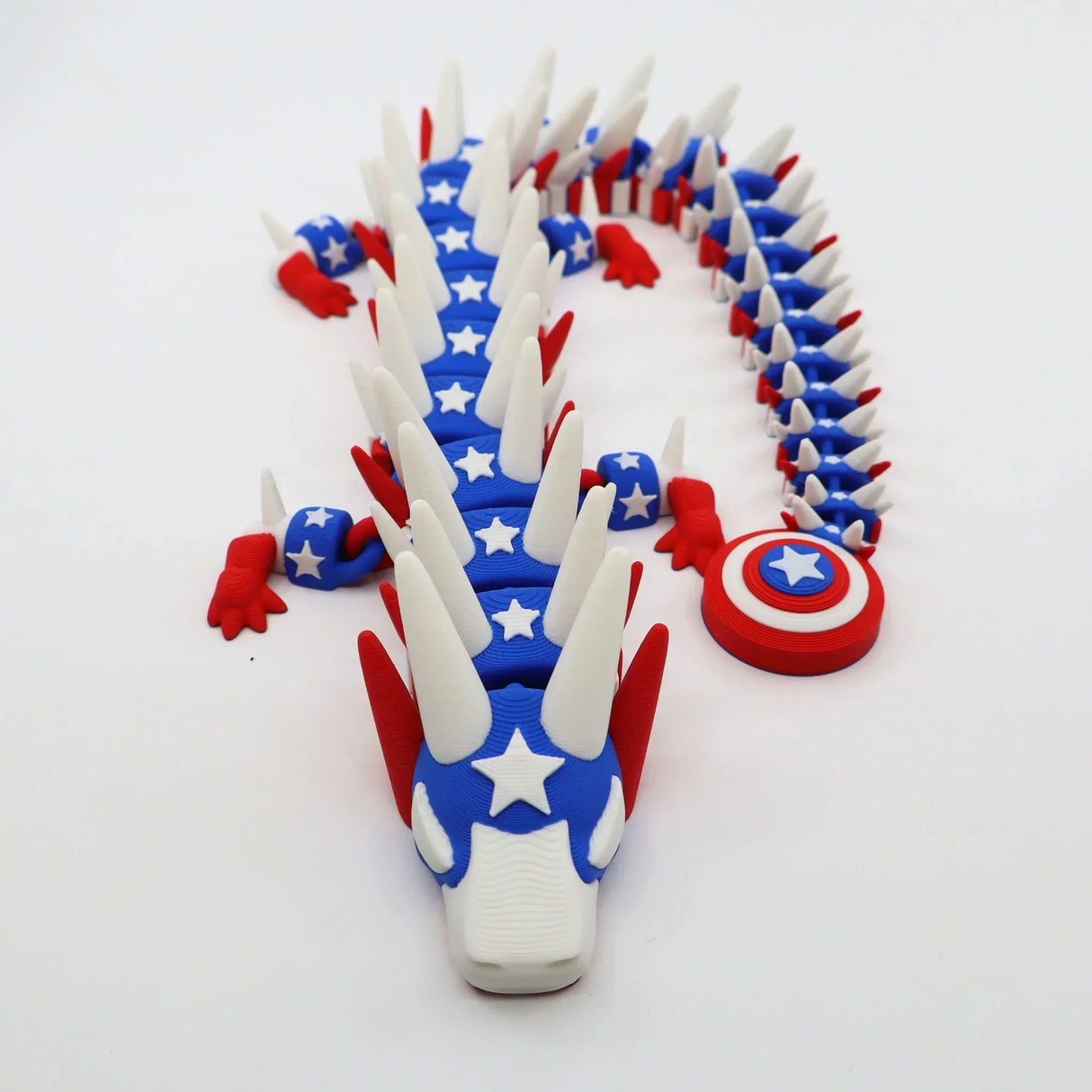 3D printed patriotic dragon fidget toy with stars, shield, and flexible segments for sensory play