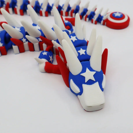 3D printed patriotic flexi dragon fidget toy with stars, stripes, and shield for sensory play