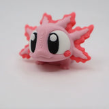 Cute pink 3D printed axolotl sensory toy with large eyes on a white background