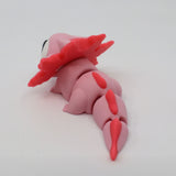 Pink 3D printed axolotl sensory toy with flexible segments on a white background