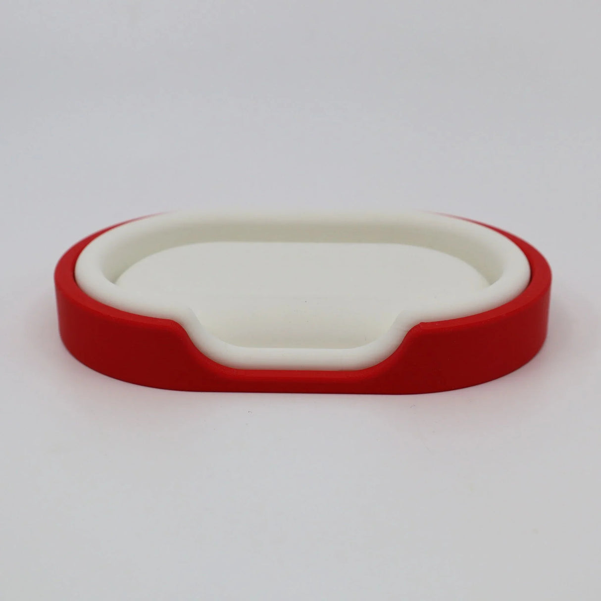 Red and white 3D printed sensory toy tray for children on white background