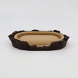 3D printed sensory toy resembling a miniature brown and beige animal bed with textured edges.