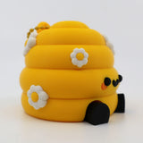 Yellow 3D printed fidget toy with daisy flowers, black wheels, and cute face for sensory play