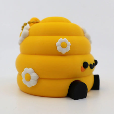 Yellow 3D printed fidget toy with daisy flowers, black wheels, and cute face for sensory play
