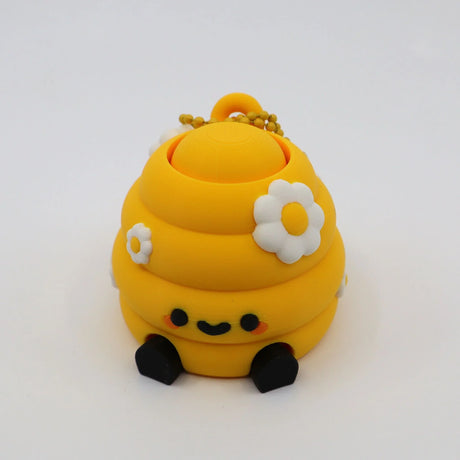 Yellow 3D printed fidget toy with daisy flowers, smiley face, and keychain for sensory play