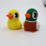 Colorful 3D printed duck fidget toys for sensory play, yellow and green with orange beaks