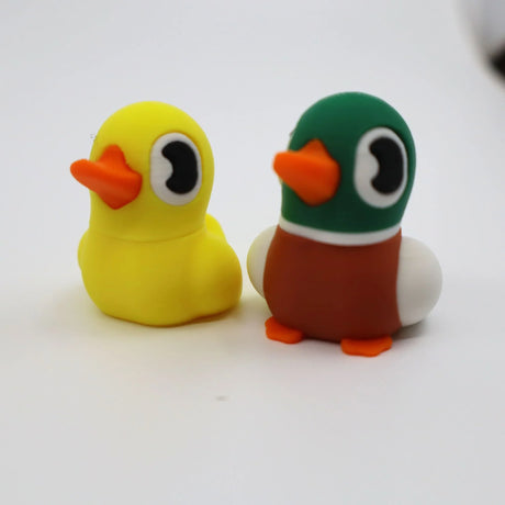 Colorful 3D printed duck fidget toys for sensory play, yellow and green with orange beaks