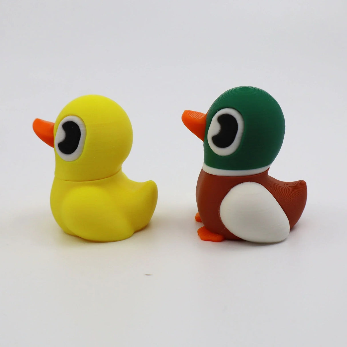 3D printed sensory duck fidget toys for kids, yellow and green-brown designs with big eyes