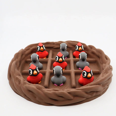 3D printed cardinal and gray bird sensory toys in a nest, perfect for fidgeting and sorting activities