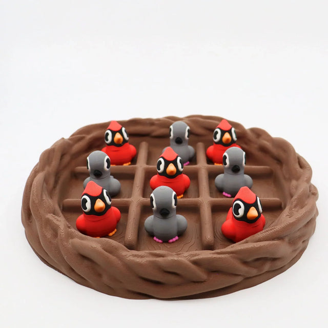 3D printed cardinal and gray bird sensory toys in a nest, perfect for fidgeting and sorting activities