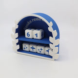 Blue and white 3D printed book tracker toy with numbered and illustrated dice in a decorative arch