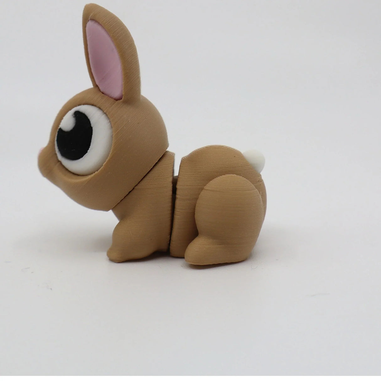 3D printed brown bunny fidget toy with big eyes and movable joints on white background