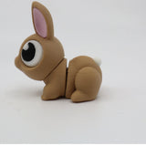 3D printed brown bunny fidget toy with big eyes and movable joints on white background
